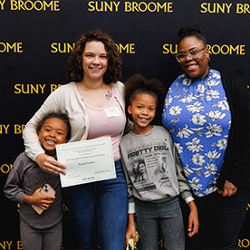 Photo of two adults holding a diploma with two children lsgp_60.jpg